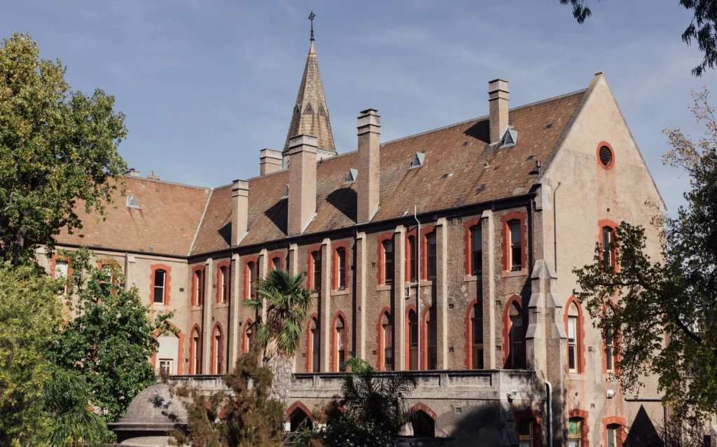 Historic Gothic-style brick facade with steep pitched roof and spire at the Abbotsford Convent arts precinct.
