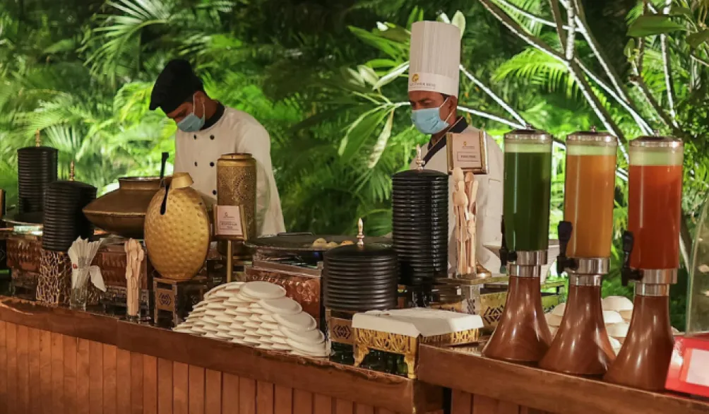 Peter Rowland hospitality staff serving guests from a custom interactive beverage bar station.