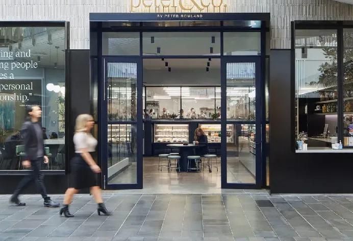 Sleek glass storefront and modern urban entrance of Peter & Co. Catering and Event Services in Docklands.