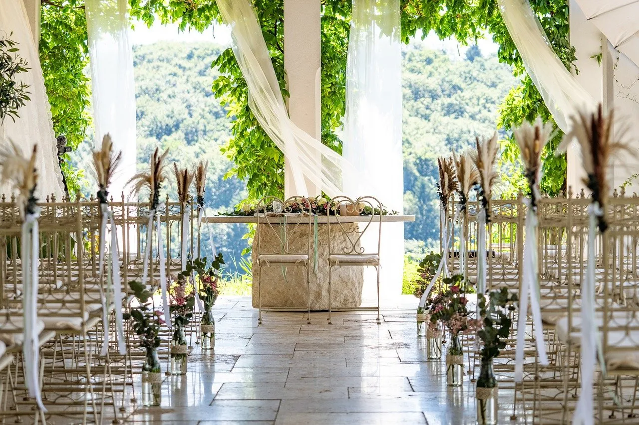 Picturesque outdoor wedding ceremony setup with floral altar drapery at a venue catered by Peter Rowland.