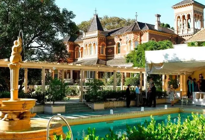 Rippon Lea Estate historic Victorian mansion grounds featuring an ornamental garden fountain and swimming pool terrace.